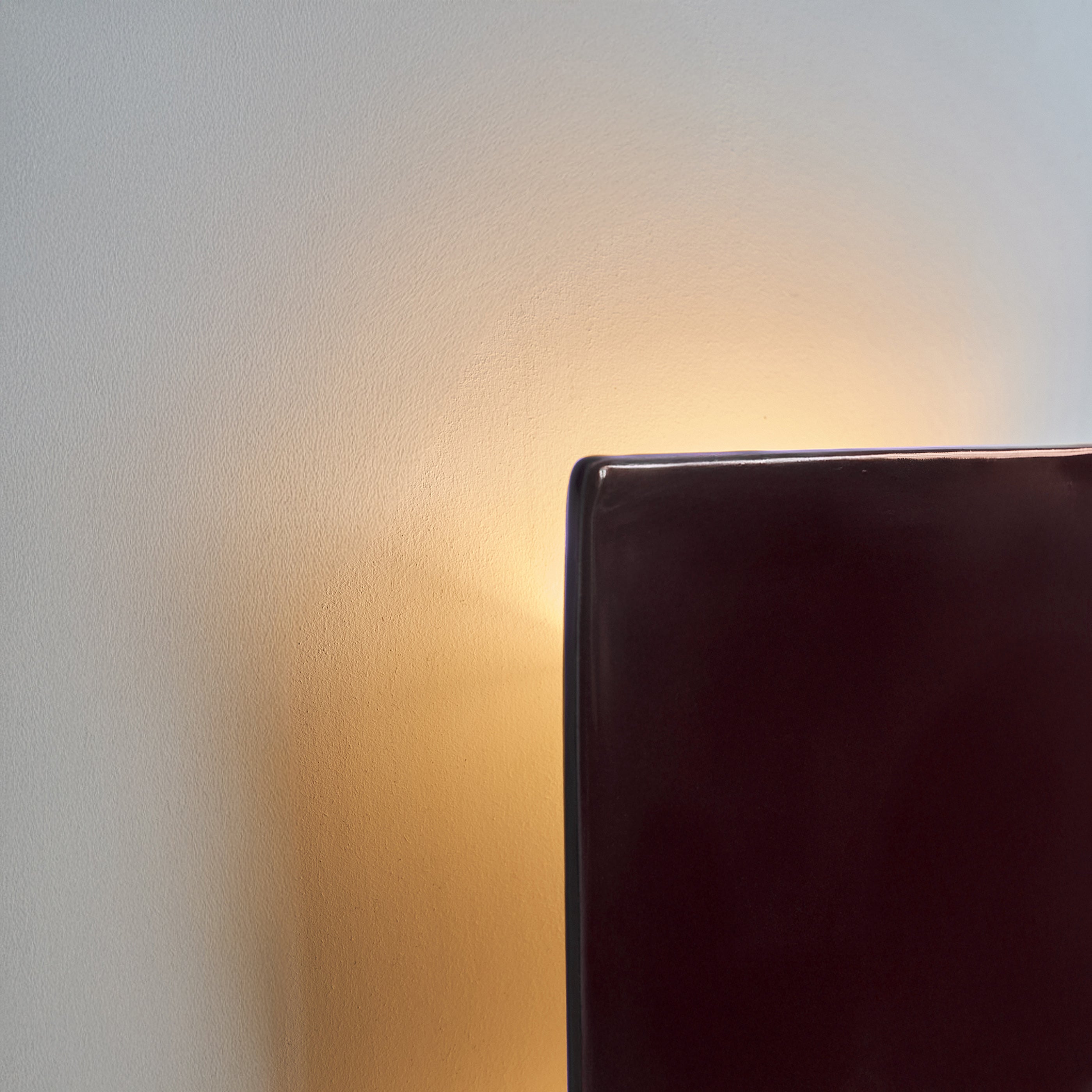 Ceramic wall light creating a soft ambient glow